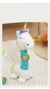 Detail of plush dog toy with waffle texture and rainbow mane featuring interactive squeaker
