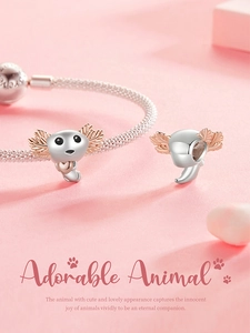 Detailed close-up of rose gold salamander charm on a silver mesh bracelet