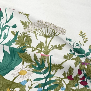 Detailed close-up showing fabric texture and floral botanical patterns of the wall tapestry