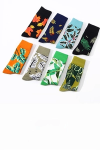 Flat lay of colorful cotton socks featuring vibrant maple and palm leaf patterns