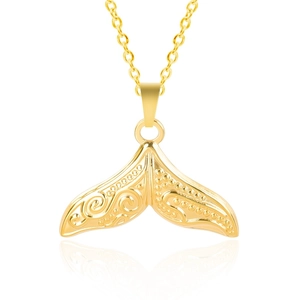 Detail of whale tail pendant with intricate floral engravings and golden polished finish