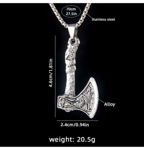 Detail of Viking axe pendant with wolf engraving and size specifications on black background