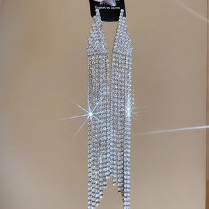 Close-up of silver tassel earrings with sparkling rhinestones in a star filter effect