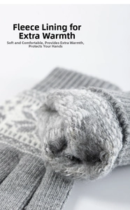 Detail of grey winter knitted gloves showing thick warm brushed fleece lining and snowflake pattern