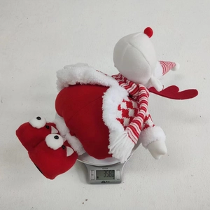 Close-up of a Christmas plush doll showing its weight of 358g on a kitchen scale