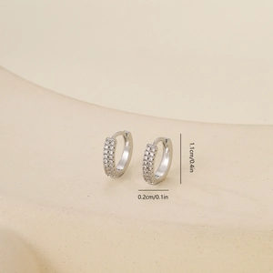 Detail view of silver zircon earrings measuring 1.1cm in diameter with size markings