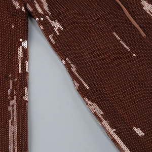 Macro detail of bronze sequins on a bodycon dress showing the fine texture and drawstring