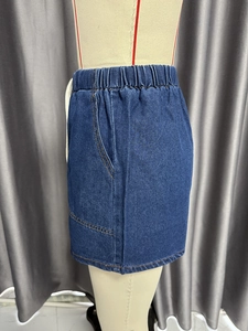 Detail of high waisted dark blue denim skirt with elastic waistband and side pockets