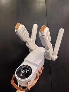Detail of shoe dryer with digital LED display showing 48 degrees and folding four-port design
