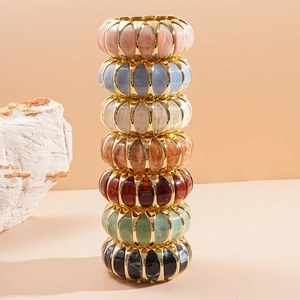 Detailed stack of wide colorful acrylic resin bangles with marble texture and gold frames