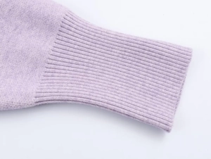 Close-up of lavender knitted cardigan showing ribbed cuff detail and soft cashmere texture