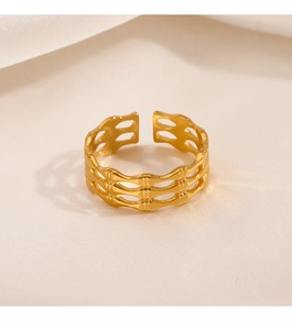 Detailed macro view of the gold hollow geometric grid pattern on an adjustable ring