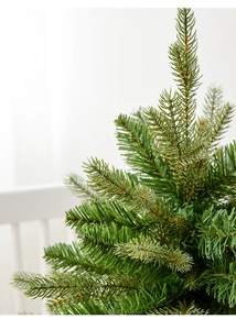 Macro detail of realistic PE and PVC pine needles on a Nordic mini Christmas tree
