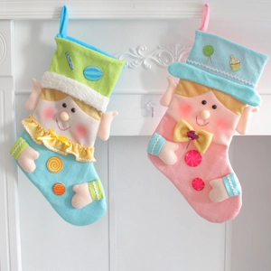 Festive felt Christmas stockings with cartoon elf designs hanging on a white fireplace mantle