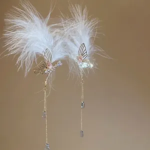 Elegant feather butterfly tassel drop earrings with crystals and blue teardrop beads