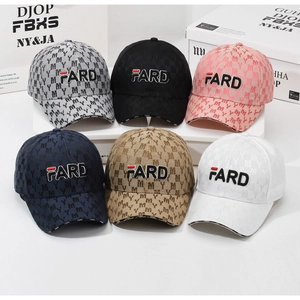 Detail of embroidered letters on multi-colored baseball caps with street style textures