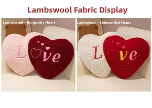 Detailed close-up of soft lamb wool texture and embroidered Love text on heart-shaped pillows