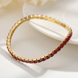 Elegant 4mm gold-plated stretch bracelet with vibrant red zircons on white ceramic