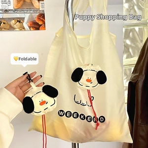 Close-up of foldable cream cartoon puppy shopping bag with portable hanging hook detail