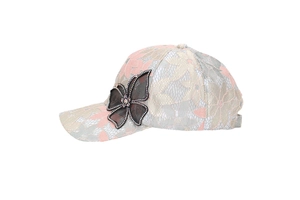 Detailed close-up of lace baseball cap featuring mesh flowers and rhinestone butterfly