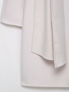 Detailed close-up of wool blend coat cuff and collar showing soft plush texture