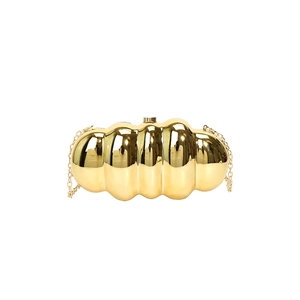 Elegant gold capsule clutch bag with wave patterns and a detachable metal chain strap