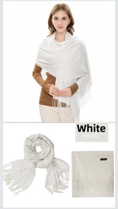 Detail view of white cashmere scarf showing elegant long fringes and soft fabric texture