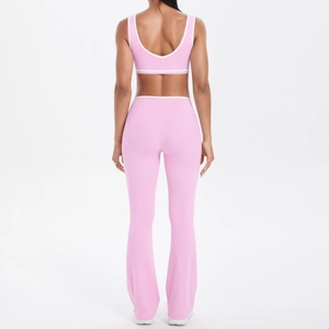 Detail view of the back U-shape cutout and white piping on the pink yoga sports bra