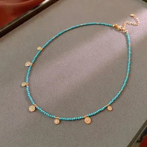 Blue beaded necklace with vintage golden coin pendants and adjustable lobster clasp