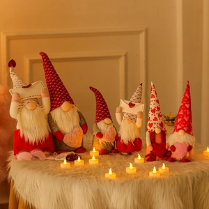 Set of six plush Valentine's Day gnomes in red and grey on a white faux fur surface