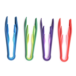 Set of four colorful plastic food tongs for baking and kitchen in blue green purple red