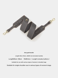 Macro detail of grey leather replacement strap with gold metal buckles and white stitching