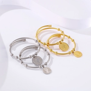 Twisted cable cuff bracelets in gold and silver with Elizabeth II coin pendants