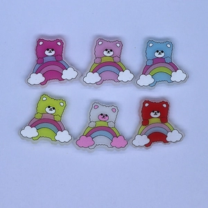 Flat lay of colorful rainbow bear resin accessories for DIY crafts and phone cases