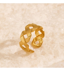 Macro shot of gold adjustable open ring featuring woven textured mesh metal detailing