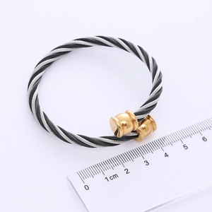 Two-tone stainless steel cable cuff bracelet with gold ball ends and measurement ruler