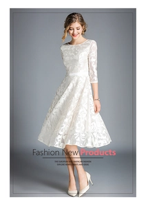 Detailed close-up of white floral lace texture and decorative slim belt on a midi dress