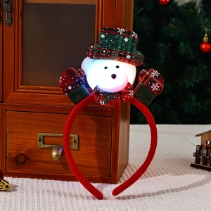 Close-up of glowing snowman headband with red plaid hat for Christmas party decor