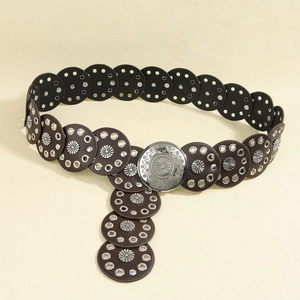 Detail of vintage Western leather belt with silver floral concho and engraved buckle