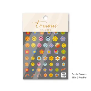 Close-up of ultra-thin nail stickers with colorful smiley faces and floral designs