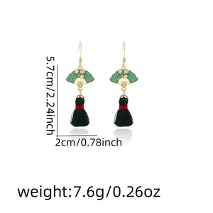 Detail view of green fan earrings with black tassels showing size 5.7cm by 2cm dimensions