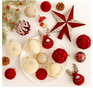 Flat lay of red velvet and gold glitter Christmas ornaments with pine cones on white background