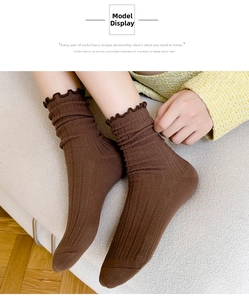 Close-up of brown cotton socks with ruffled edges and vertical ribbed texture design