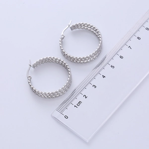 Detailed view of silver twist hoop earrings measuring approximately 2.5cm with ruler
