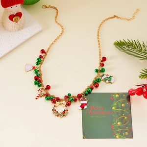 Christmas necklace with gold chain and colorful bell, tree, and wreath charms