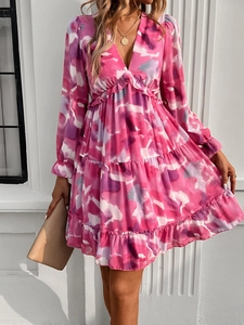 Detailed close-up of pink tie-dye print dress with V-neck and layered ruffle skirt