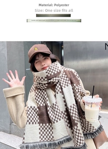 Close-up of beige and brown plaid scarf featuring soft polyester texture and fringe detail