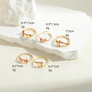 Set of five vintage gold rings with snake and star designs featuring size measurements