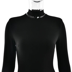 Detail showing high neck collar and smooth elastic fabric of the black long sleeve jumpsuit