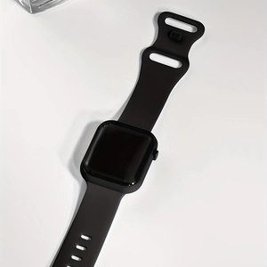 Top view of square black digital sports watch with silicone strap on white background